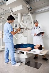 Image showing Radiologists Performing X-ray On Patient