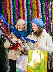 Image showing Mother And Daughter Selecting Tinsels At Store