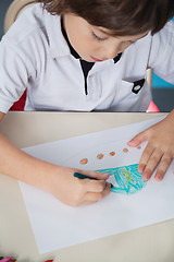 Image showing Boy Drawing With Color Pencil In Classroom