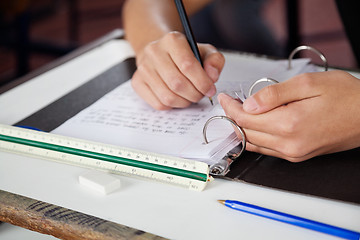 Image showing Schoolboy Copying At Desk During Examination