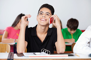 Image showing Teenage Male Student Using Phone In Classroom