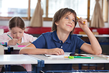 Image showing Little Boy Smiling While Looking Up In Classroom