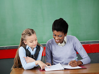 Image showing Schoolgirl Asking Question To Teacher At Desk