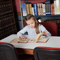 Image showing Schoolgirl Reading Books At Table