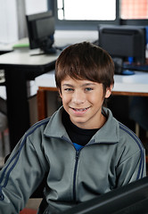 Image showing Happy Schoolboy Sitting In Computer Class