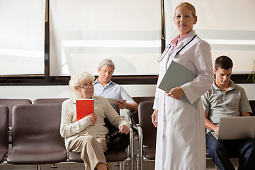 Image showing Doctor With People In Hospital Lobby