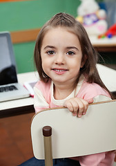 Image showing Girl Sitting On Chair With Laptop On Desk In Classroom