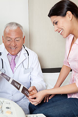 Image showing Radiologist Showing Ultrasound Print To Patient