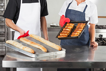 Image showing Chefs Holding Trays Of Baked Bread