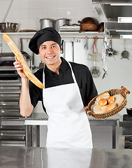 Image showing Male Chef Holding Bread Loaf