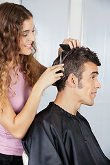 Image showing Female Hairdresser Cutting Client's Hair