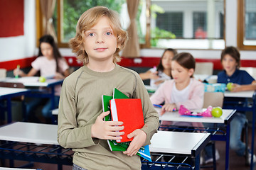 Image showing Schoolboy Holding Books