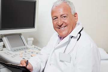 Image showing Radiologist Writing On Clipboard