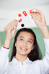 Image showing Schoolgirl Looking At Molecular Structure In Classroom