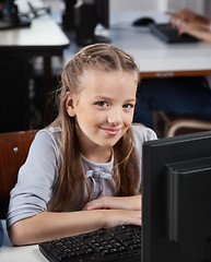 Image showing Cute Schoolgirl With Computer At Desk