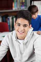 Image showing Teenage Schoolboy Sitting In Library