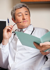 Image showing Doctor Reading Medical Report