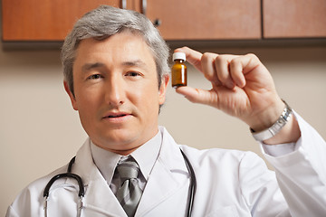 Image showing Physician Holding Medicine Bottle