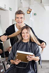 Image showing Hairstylist With Client Holding Mirror At Salon