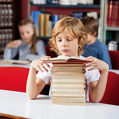 Image showing Schoolboy With Stack Of Books