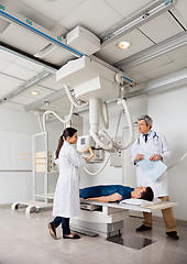 Image showing Radiologists With Patient In X-ray Room