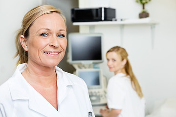 Image showing Female Doctor Smiling With Colleague In Background