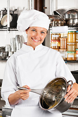 Image showing Happy Chef Mixing Egg With Wire Whisk