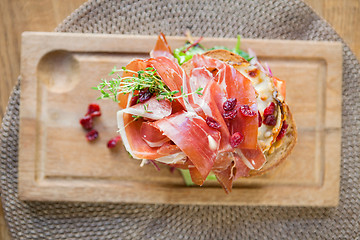 Image showing Delicious Parma Ham Sandwich On Wooden Plate