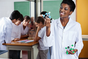 Image showing Female Teacher Looking At Molecular Structure