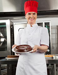 Image showing Female Chef Presenting Chocolate Cake