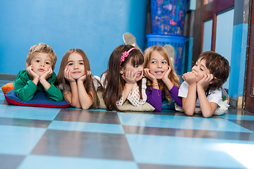 Image showing Children Lying In A Row On Floor