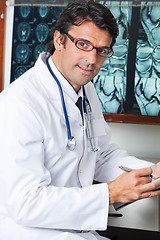 Image showing Male Doctor Sitting At Desk