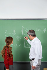 Image showing Teacher Teaching Mathematics To Teenage Schoolgirl