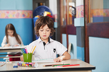 Image showing Boy With Color Pencils And Drawing Paper At Kindergarten