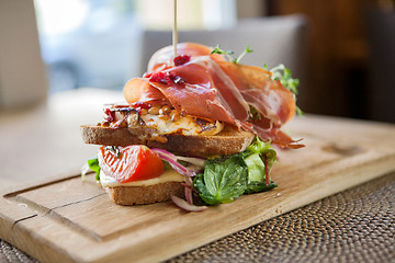 Image showing Tasty Parma Ham Sandwich On Wooden Plate