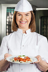 Image showing Cheerful Chef Presenting Dish