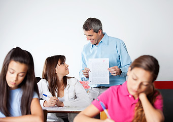 Image showing Male Professor Showing Paper To Student During Examination