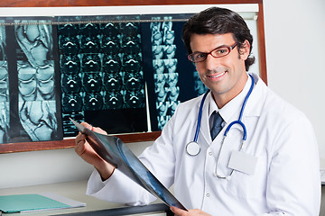 Image showing Happy Radiologist Holding X-ray