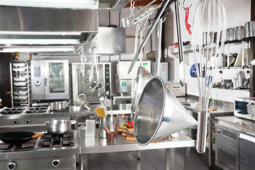 Image showing Utensils Hanging In Commercial Kitchen