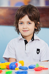 Image showing Cute Boy With Blocks On Desk At Kindergarten