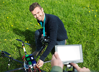 Image showing Engineer Fixing UAV Helicopter in Park