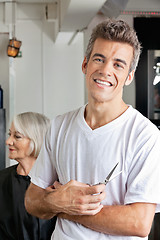 Image showing Hairstylist Holding Scissors In Salon