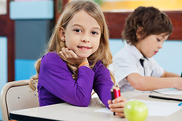 Image showing Girl Holding Color Pencils With Friend Drawing In Background