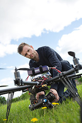 Image showing Engineer Fixing Camera On UAV Helicopter