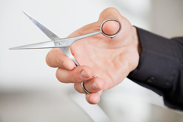 Image showing Male Hairdresser's Hand Holding Scissors