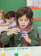 Image showing Little Boy Looking At Watercolor