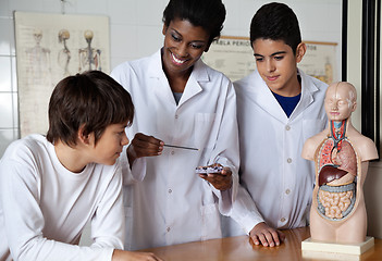 Image showing Teacher With Male Students Experimenting At Desk