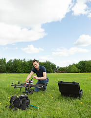 Image showing Technician Preparing Multirotor Helicopter