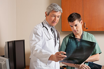 Image showing Doctor And Technician Reviewing X-ray