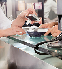 Image showing Customer Paying With Mobilephone Using NFC